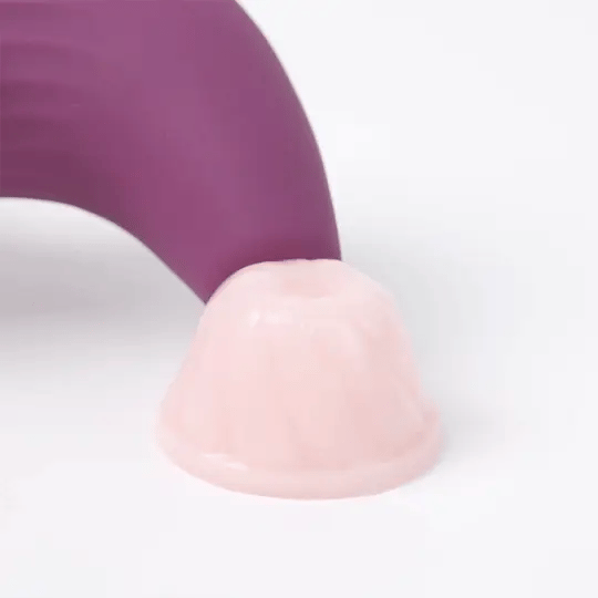 Close-up of the Svakom Pulse Union stimulator positioned over a soft silicone surface, demonstrating the suction function of the air-pulse nozzle.