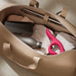 Nova Rabbit Vibrator packed inside an open travel bag next to everyday items like clothing and a water bottle