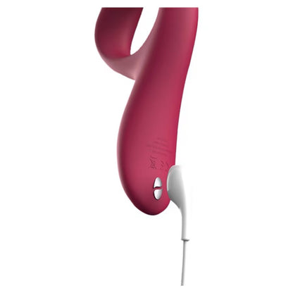 Close-up of Nova Rabbit Vibrator with magnetic charging cable connected to the base